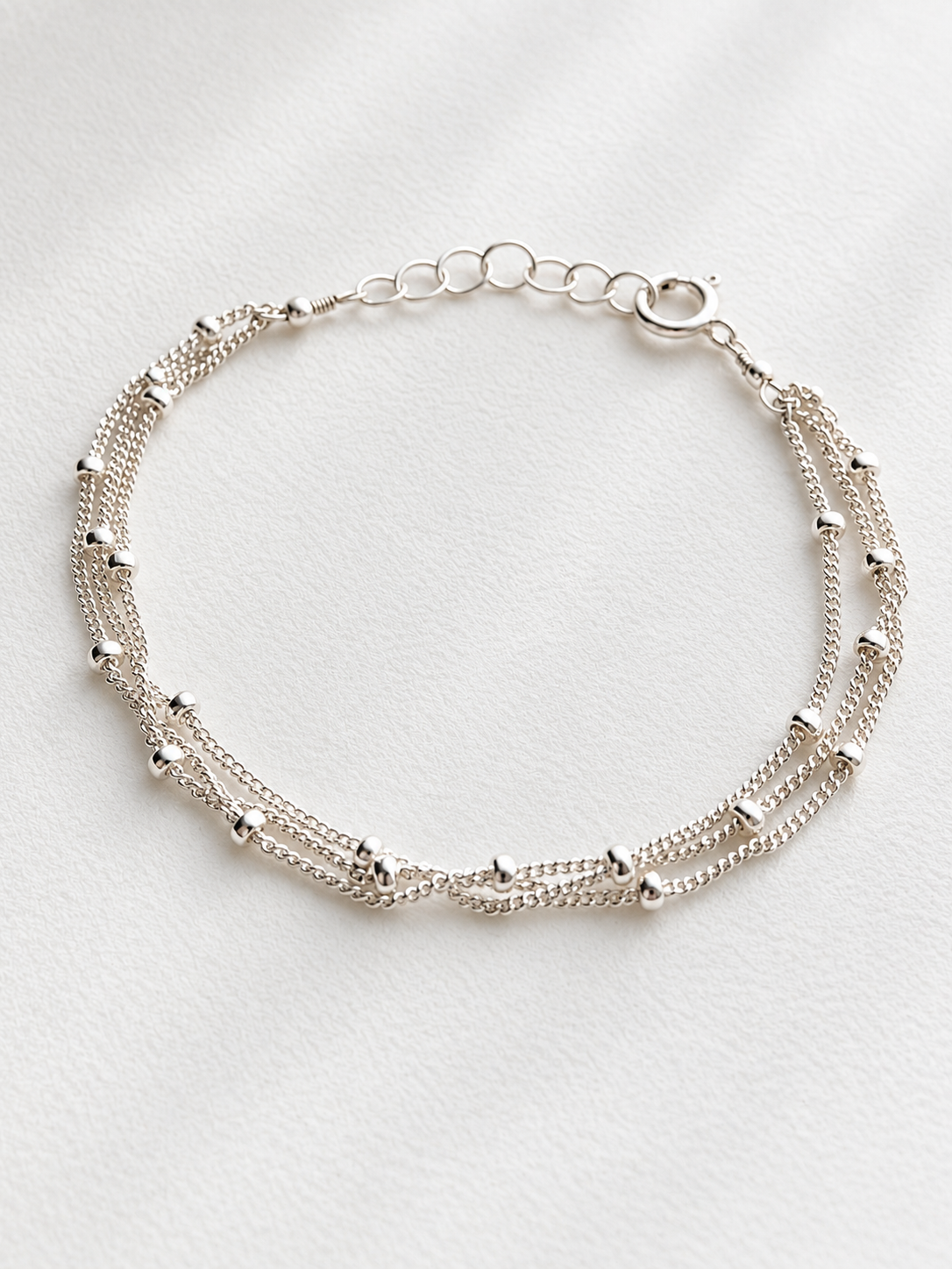 Simple, dainty, and perfect for everyday wear. This Satellite Chain Bracelet features tiny polished beads along a delicate chain for a subtle touch of shine.
Choose from 1, 2, or 3 strands to create your favorite look. Wear it alone for a minimal style or stack it with your favorite bracelets.