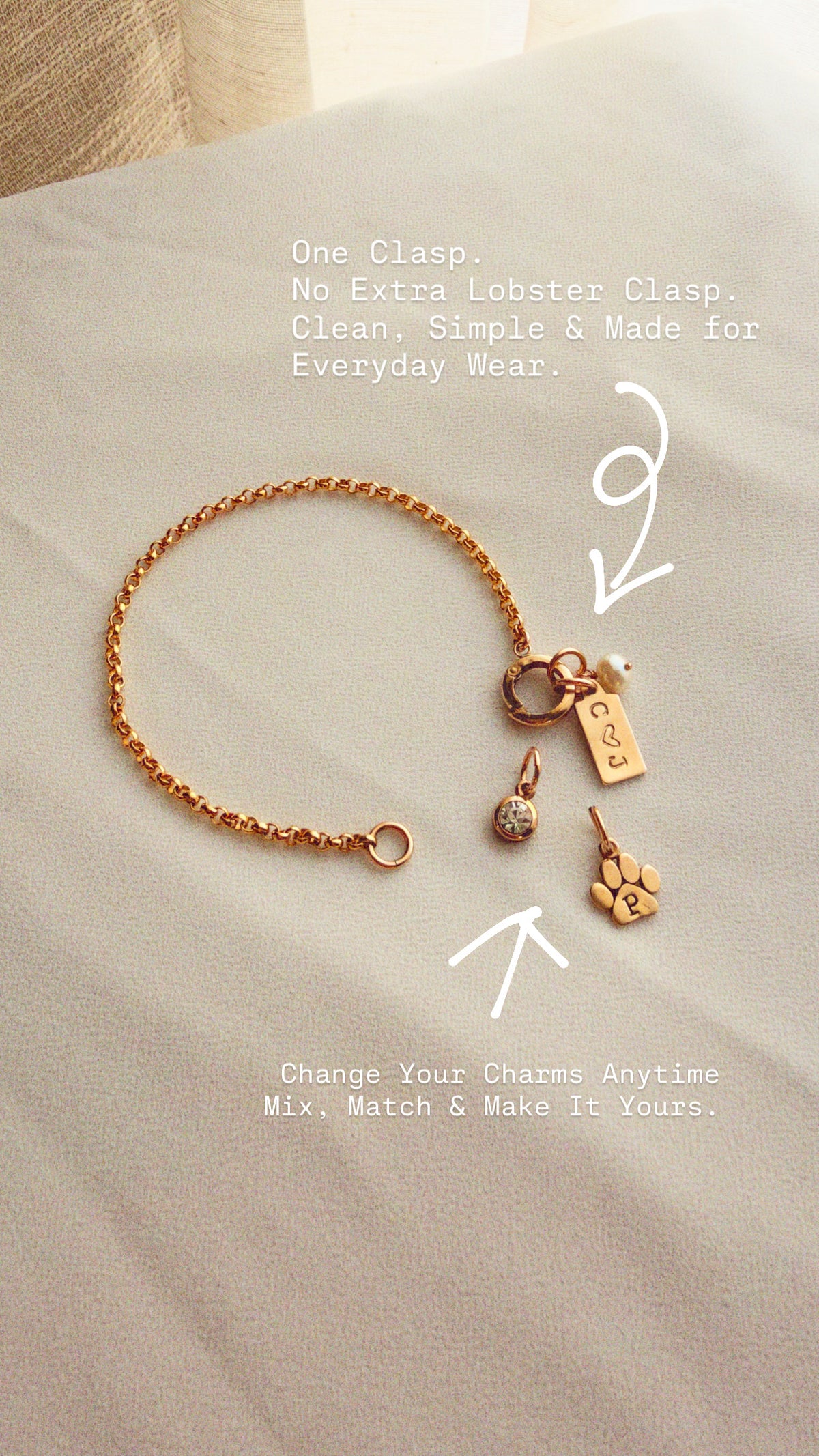 Custom fit gold filled charm holder bracelet with interchangeable initial, birthstone, pearl, and paw print charms, featuring a single push clasp for easy personalization.