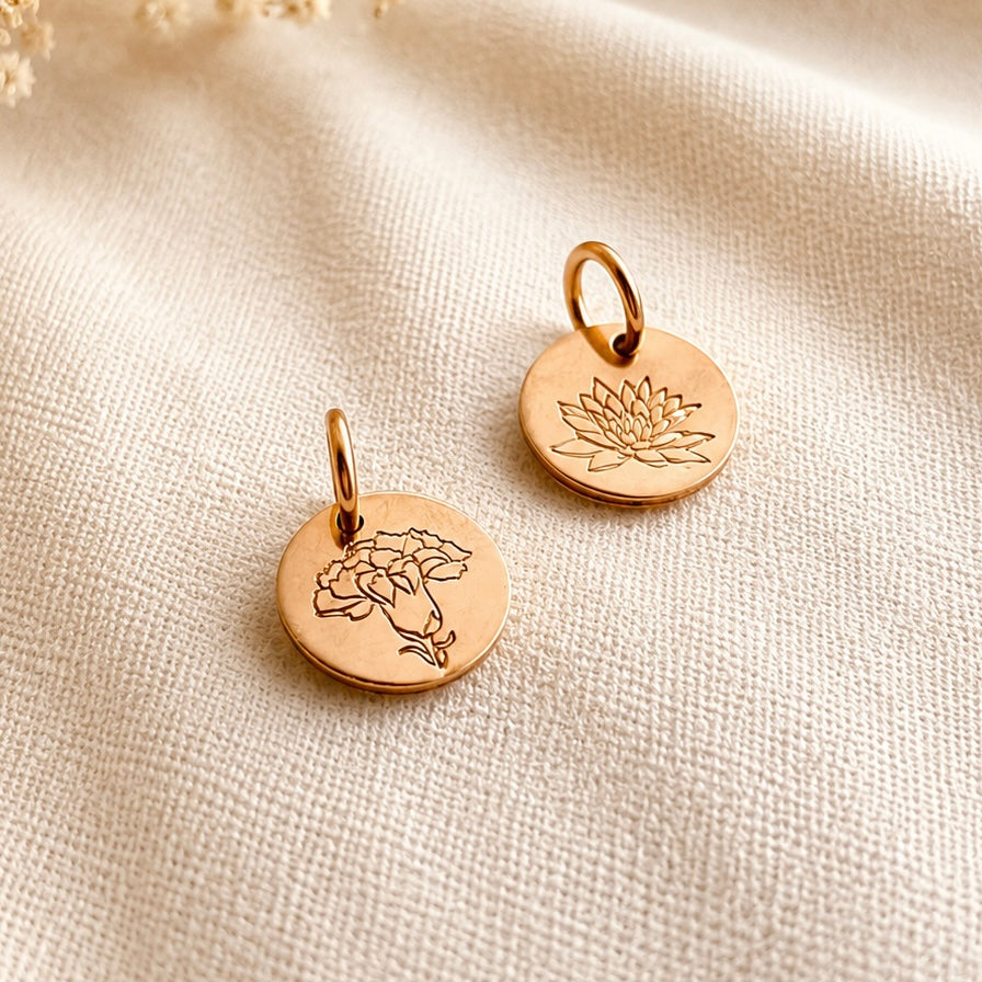 Personalized hand-stamped birth flower pendants in 14K gold filled and sterling silver with botanical and floral designs