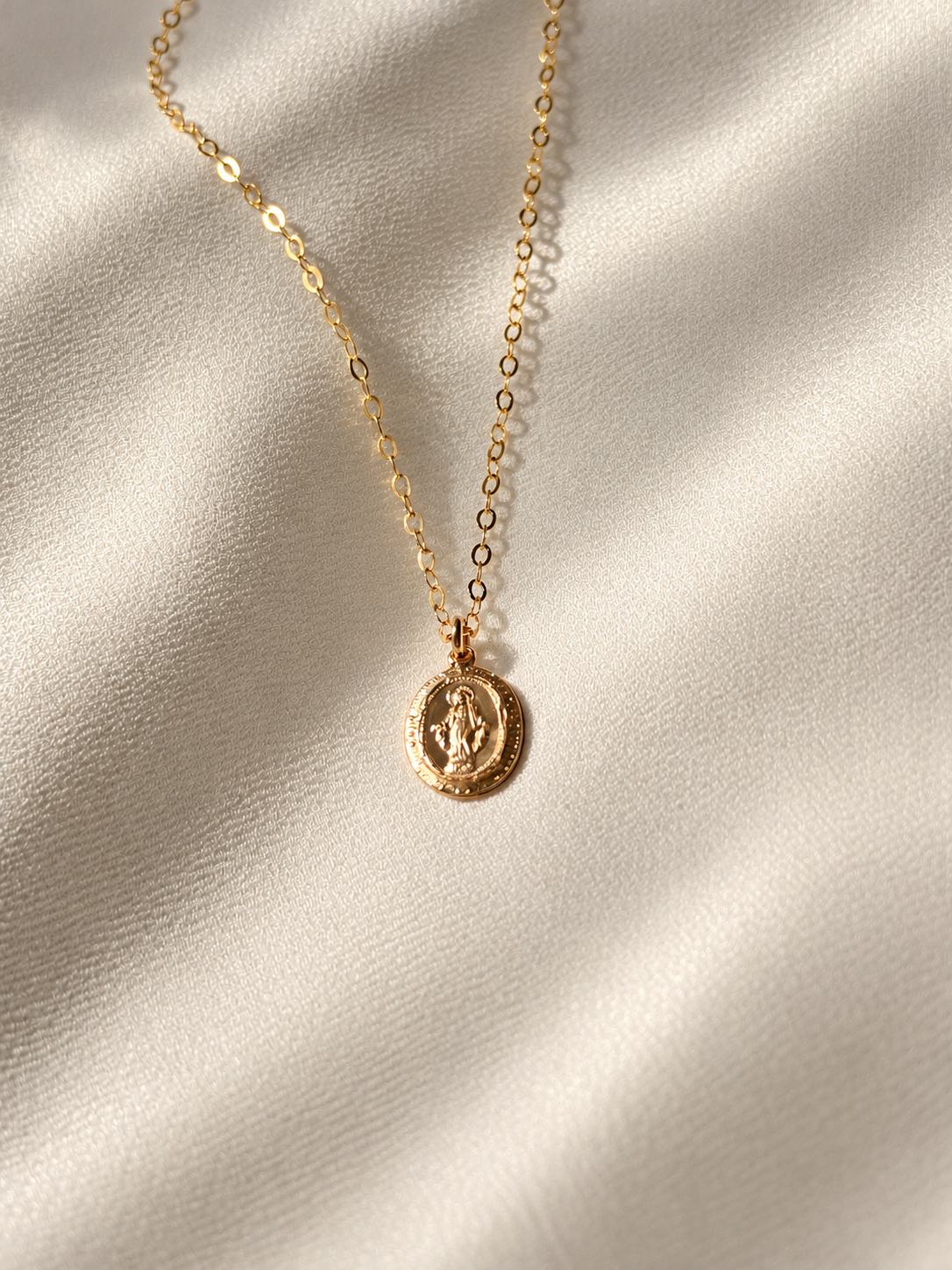 Dainty 14K gold filled Virgin Mary necklace with tiny 9x13mm oval double-sided religious medal on a delicate gold chain