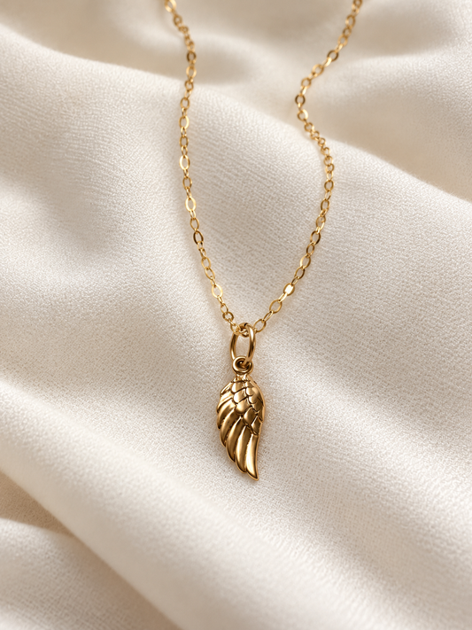 Gold Dainty 14K gold filled chain necklace with 16mm bronze angel wing charm on ivory fabric