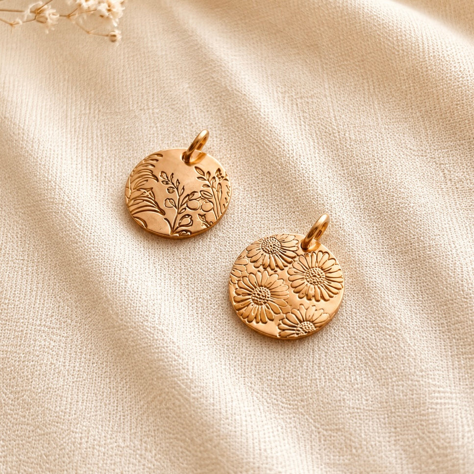 Personalized hand-stamped birth flower pendants in 14K gold filled and sterling silver with botanical and floral designs