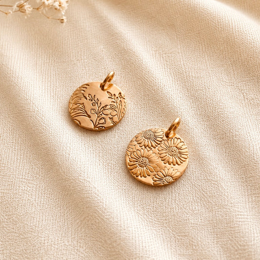 Personalized hand-stamped birth flower pendants in 14K gold filled and sterling silver with botanical and floral designs