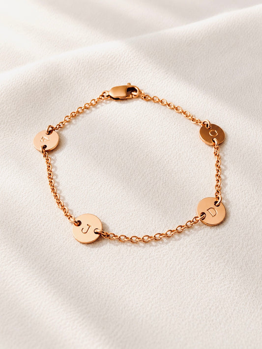 14K gold filled initial bracelet, Carry your favorite people with you, wherever life takes you.
Each tiny initial disc represents someone special — your children, your family, or the people who mean the most to you.