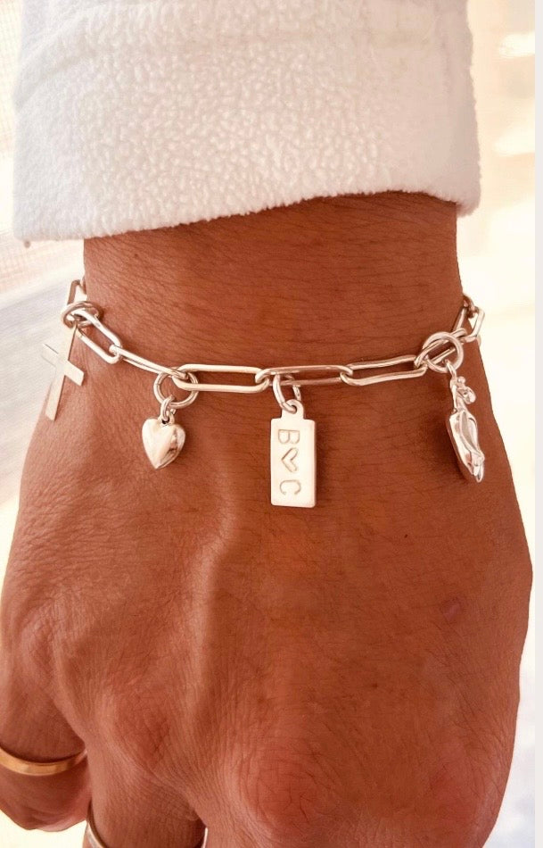 Handmade sterling silver custom charm bracelet with heart pearl cross paw print and personalized initial charms