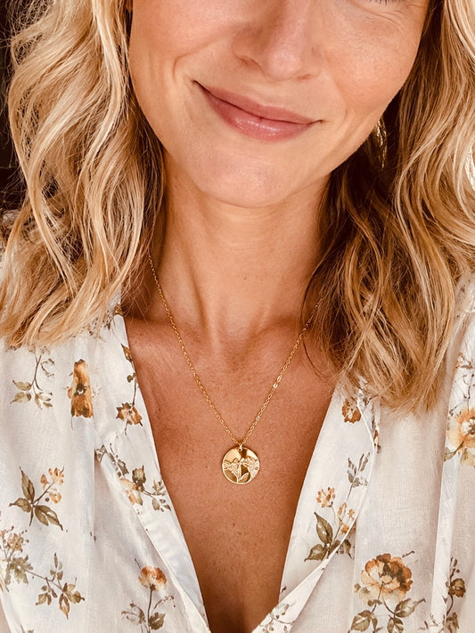 14K gold filled lily flower necklace with 15mm hand-stamped floral pendant worn as everyday jewelry