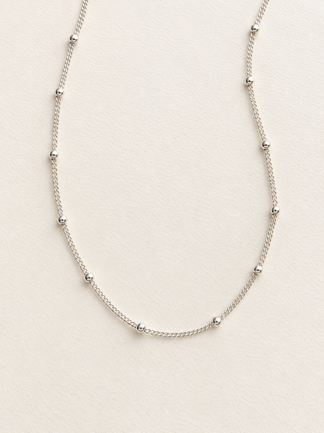 This sterling silver Satellite Chain Necklace features tiny polished beads along a delicate chain for just the right amount of shine.