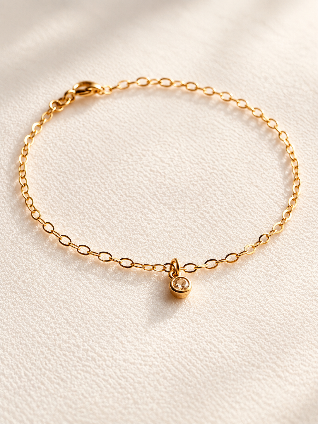 This super dainty bracelet features a tiny bezel-set CZ charm suspended from a delicate 14K gold filled chain. Lightweight, timeless, and designed for everyday wear, it’s perfect worn alone or layered with your favorite bracelets.