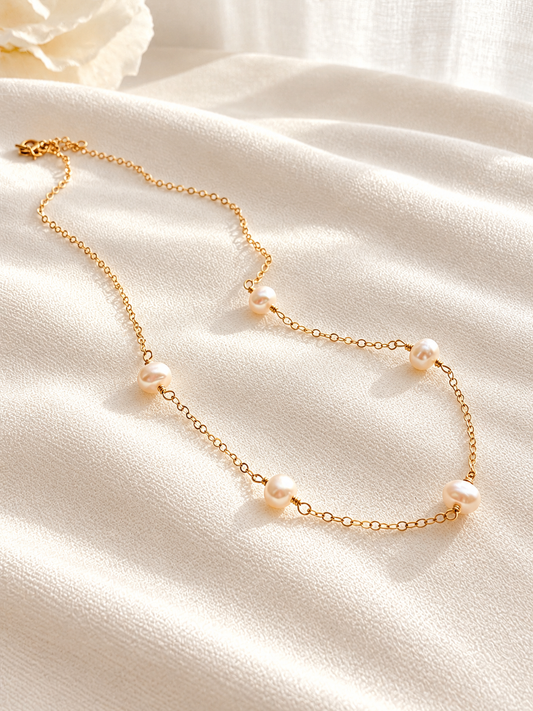 Dainty freshwater pearl station necklace available in 14K gold filled or sterling silver. Handmade with naturally unique pearls for everyday wear, layering, weddings and gifting.