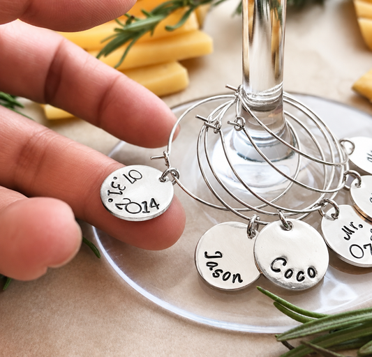 Personalized silver plated wine glass charms with hand stamped names and dates, handmade custom wine markers.