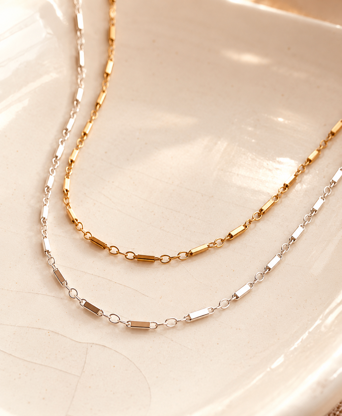 The Victoria Dainty Chain Necklace by Coco Wagner Design is a minimalist everyday necklace available in 14K gold filled and sterling silver. Featuring delicate bar and oval links, this lightweight, water-friendly necklace is designed for everyday wear, layering, and personalized charm styling.