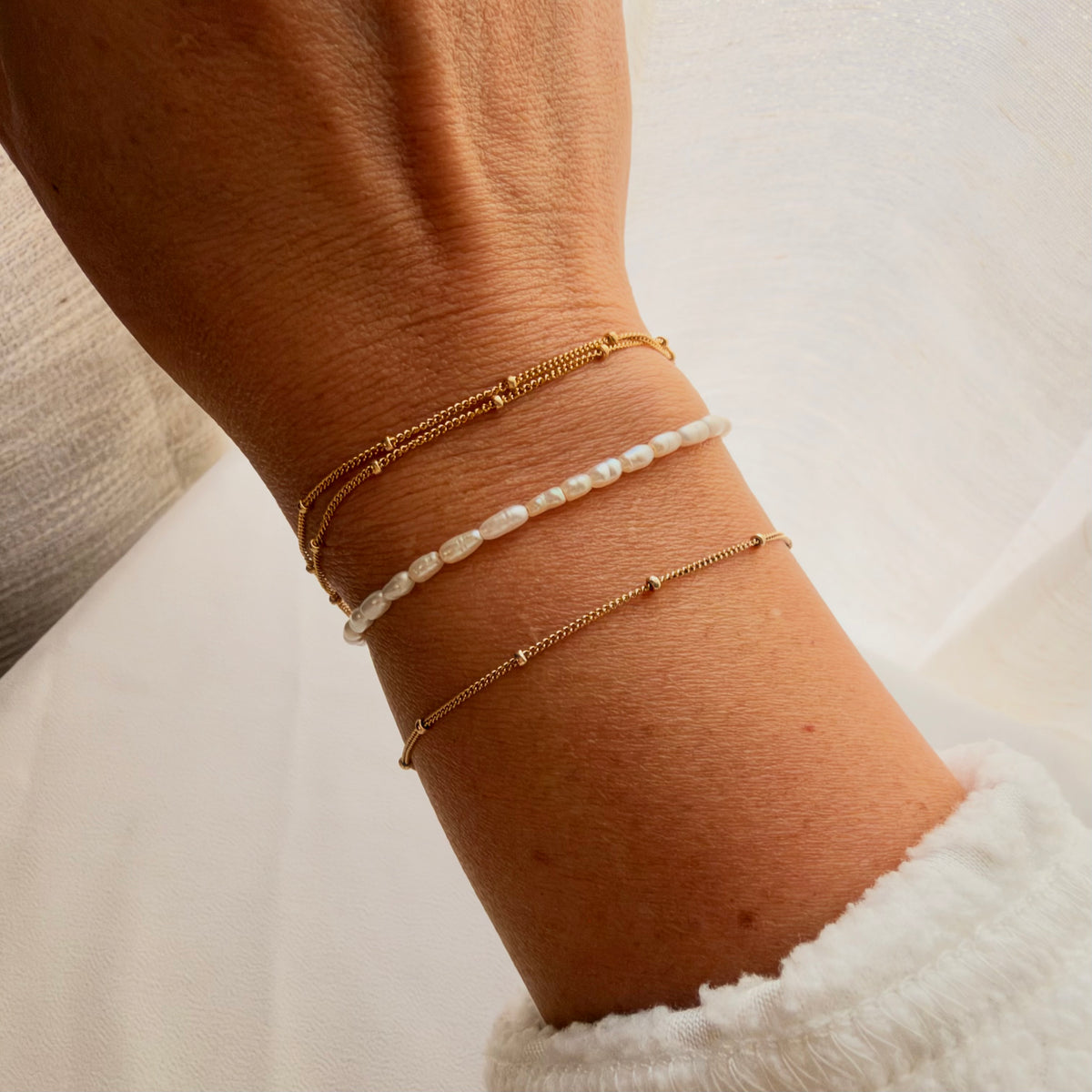Simple, dainty, and perfect for everyday wear. This Satellite Chain Bracelet features tiny polished beads along a delicate chain for a subtle touch of shine.

Choose from 1, 2, or 3 strands to create your favorite look. Wear it alone for a minimal style or stack it with your favorite bracelets.