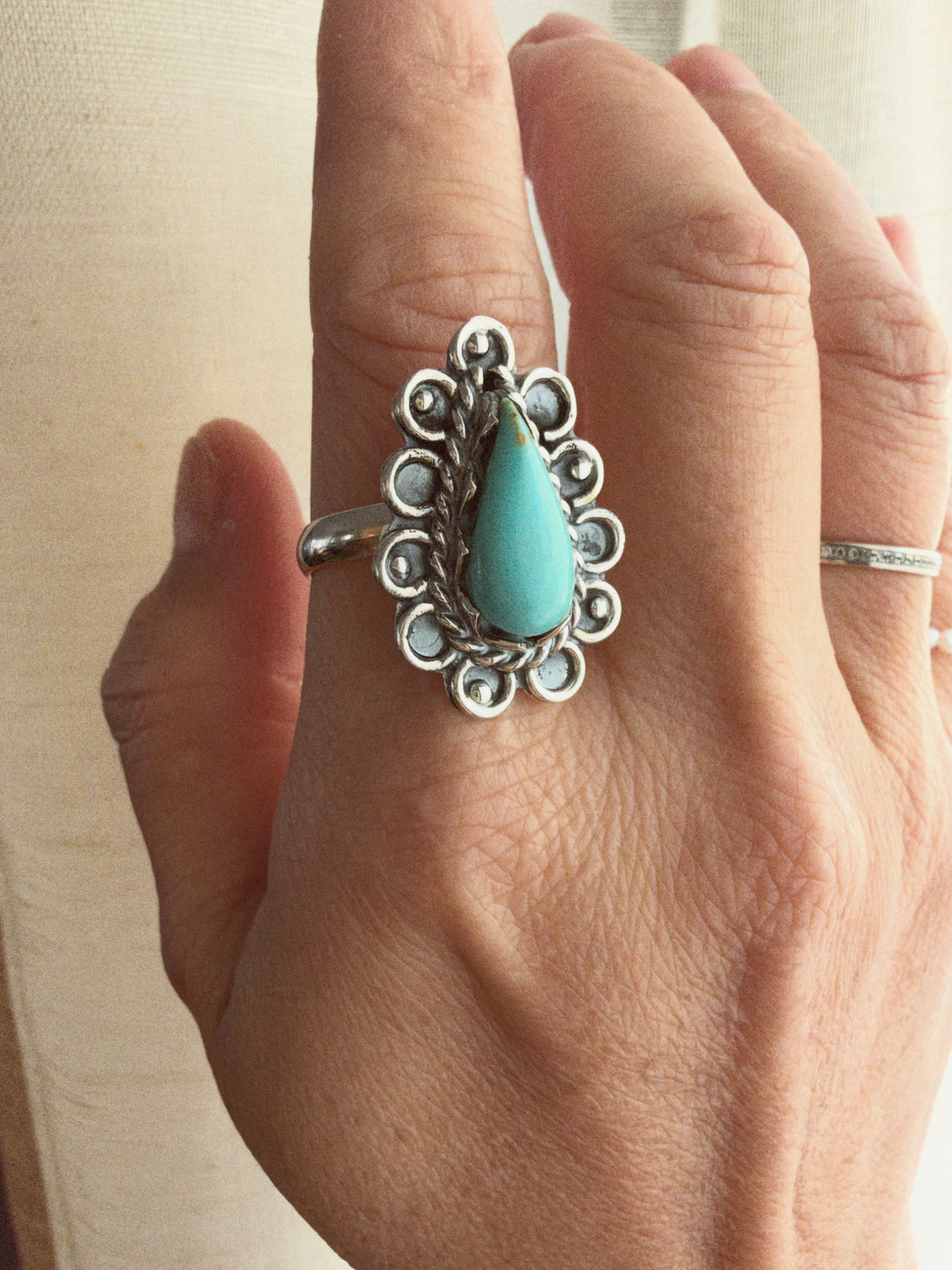 Pear shaped imitation turquoise ring with oxidized sterling silver scrollwork