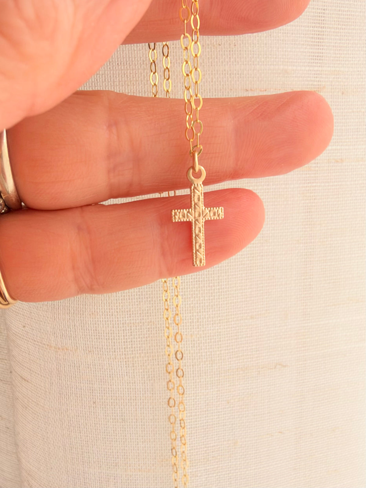 A dainty 14K Gold Filled Cross Necklace featuring a tiny 8x15mm double-sided cross charm. Lightweight, timeless Christian jewelry for 24/7 everyday wear.