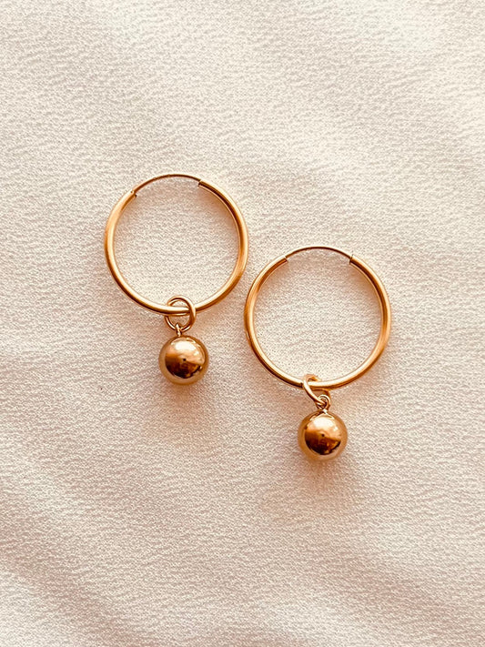 Crafted entirely from 14k gold filled and sterling silver materials, these minimalist hoops are durable, tarnish resistant with proper care, and easy to pair with everything from casual outfits to dressy occasions. Wear them alone for a clean, modern look or stack them with your favorite earrings.