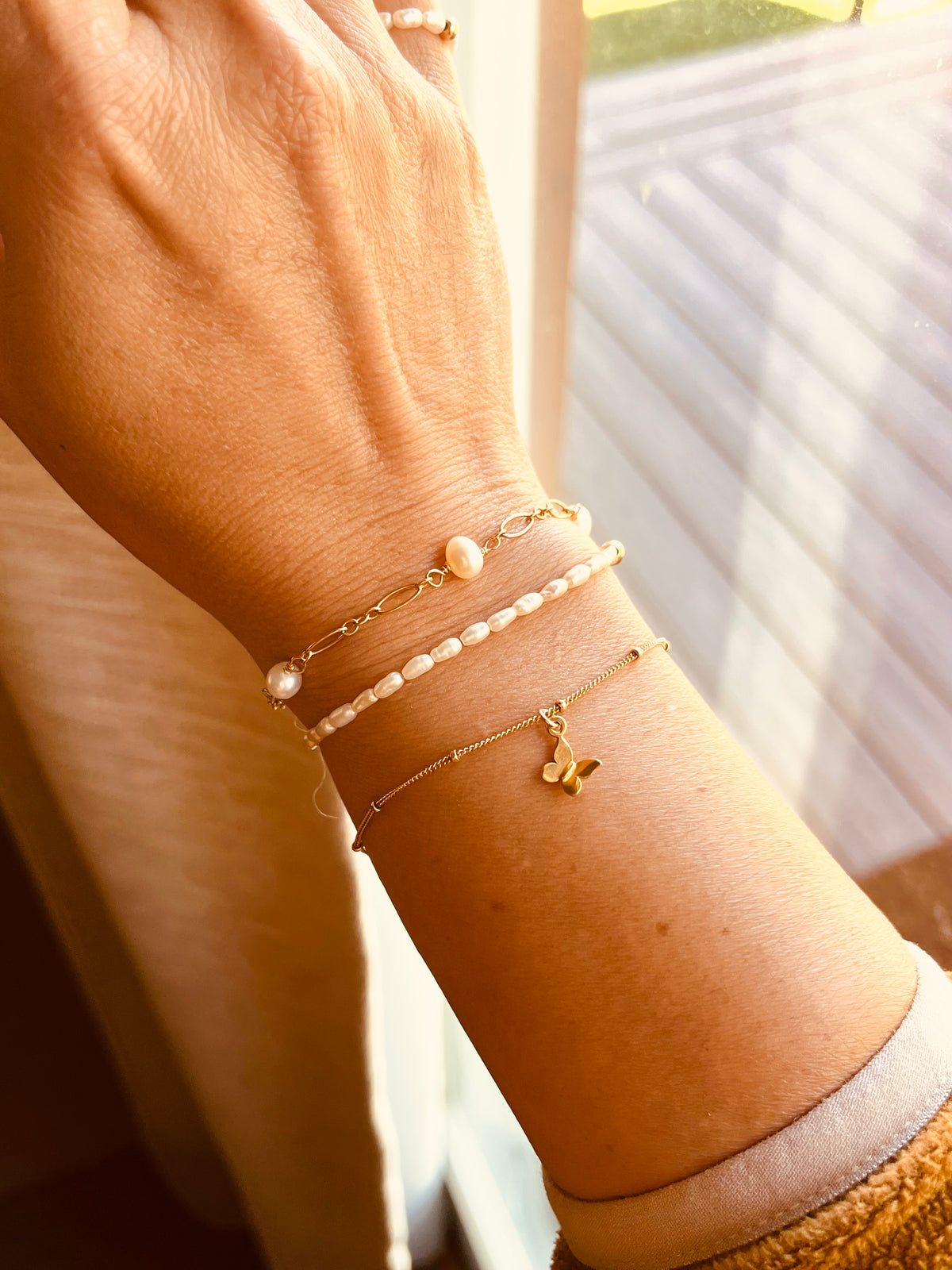 14K gold filled freshwater pearl bracelet stacked with dainty bracelets