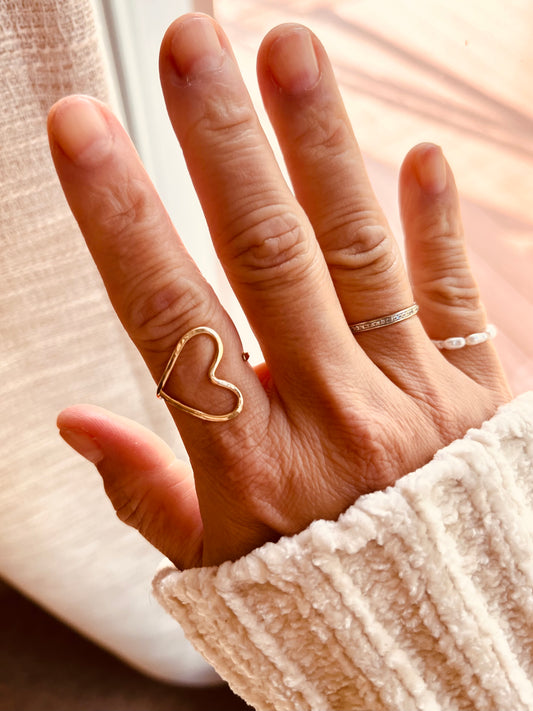 Handmade adjustable 14k gold filled heart ring worn with minimalist stacking rings
