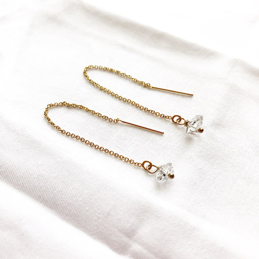 Minimalist Herkimer quartz crystal threader earrings on a white background